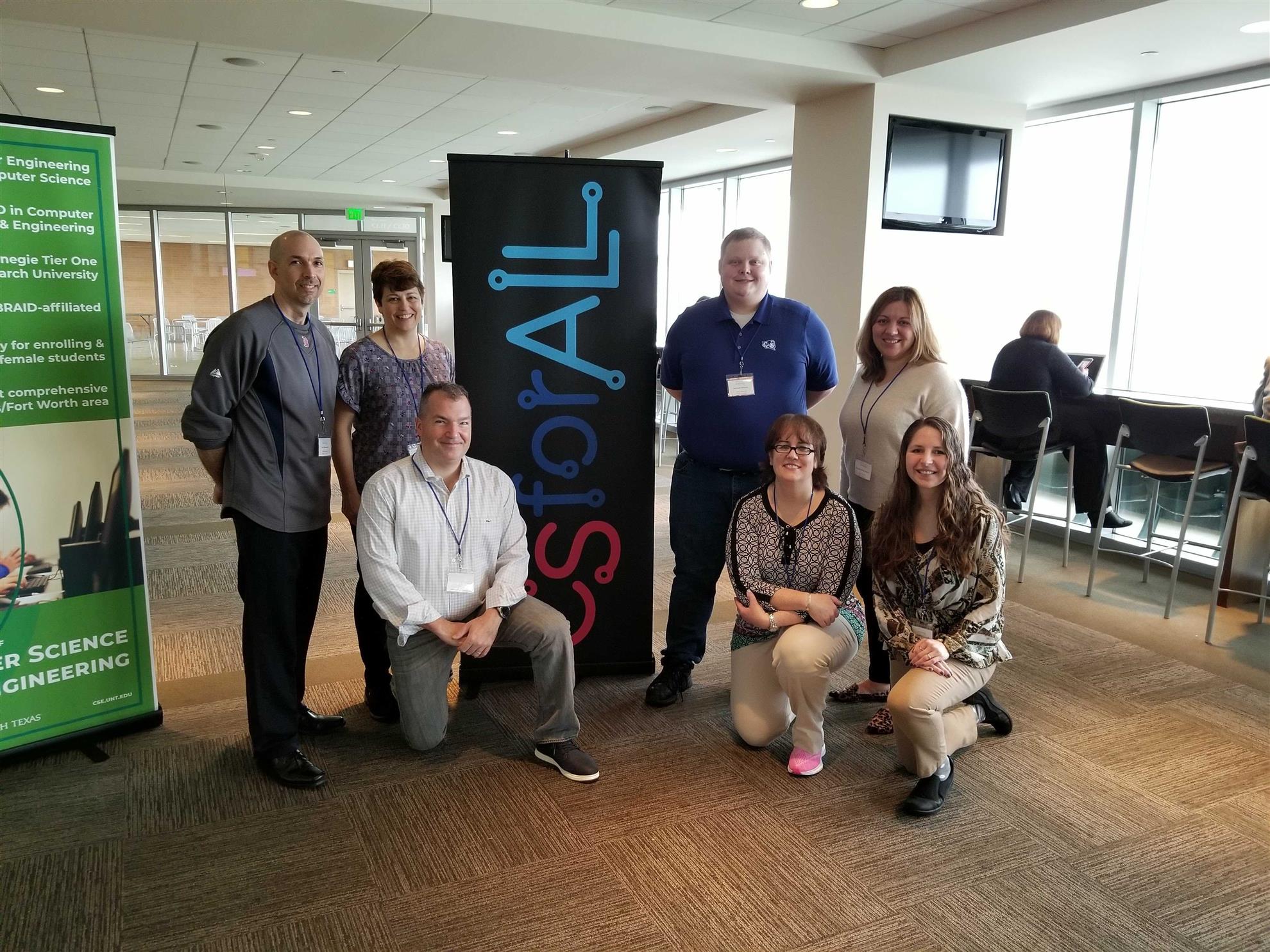Group photo in front of CSforALL banner