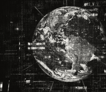 Black and white photo of the earth with an overlay of code and computer-based text.