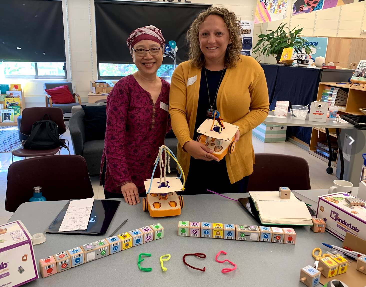 Two early-childhood teachers pose with the KIBO robot project