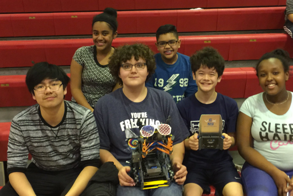 Students posing with their robot