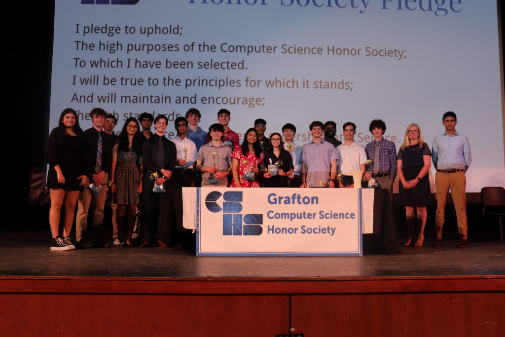 A group photo of members of the Grafton CSHS pose on stage. 