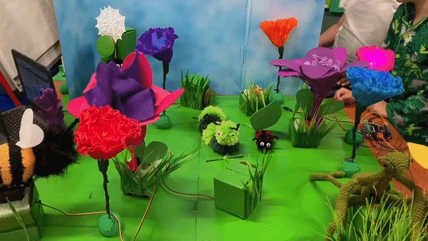 Robotic Nature Diorama with insects and flowers