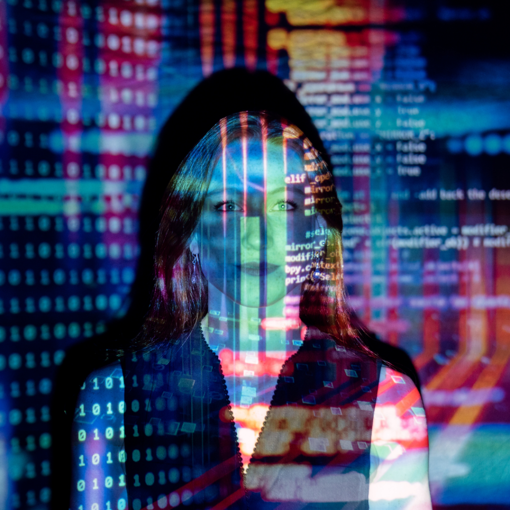 Woman Highlighted by a Projected wall of code in rainbow colors