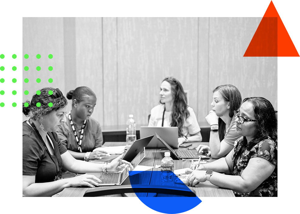 A group sitting together at conference session, laptops open