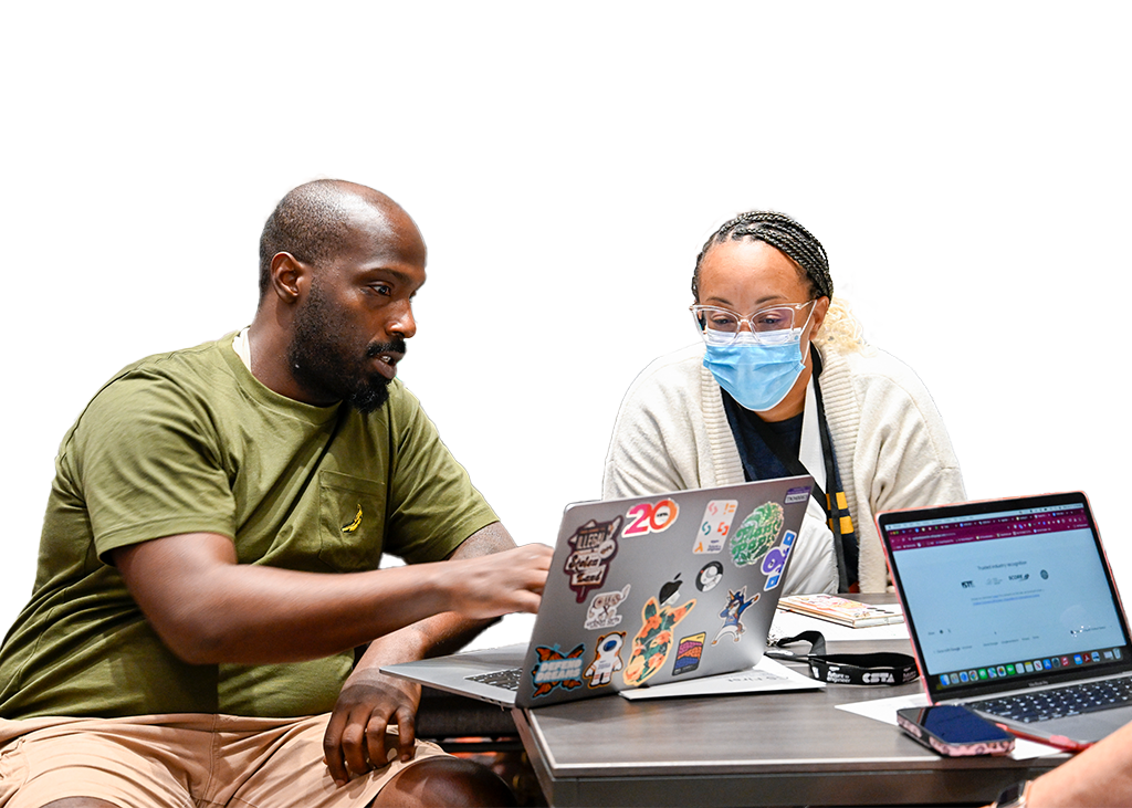 Two people looking at a laptop screen