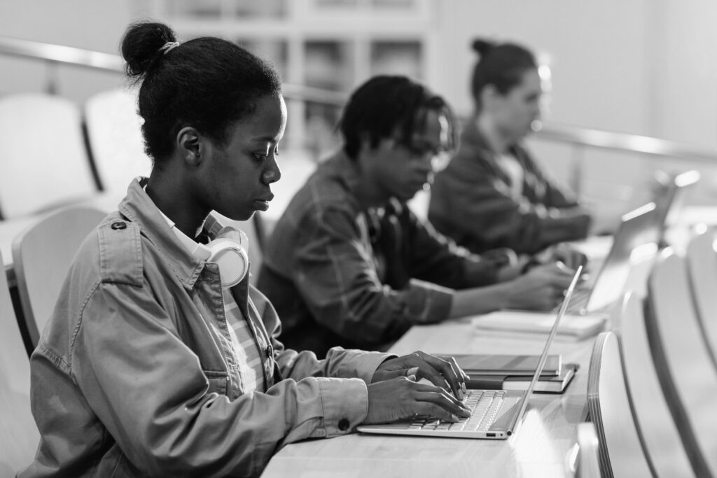 students working on laptops in class