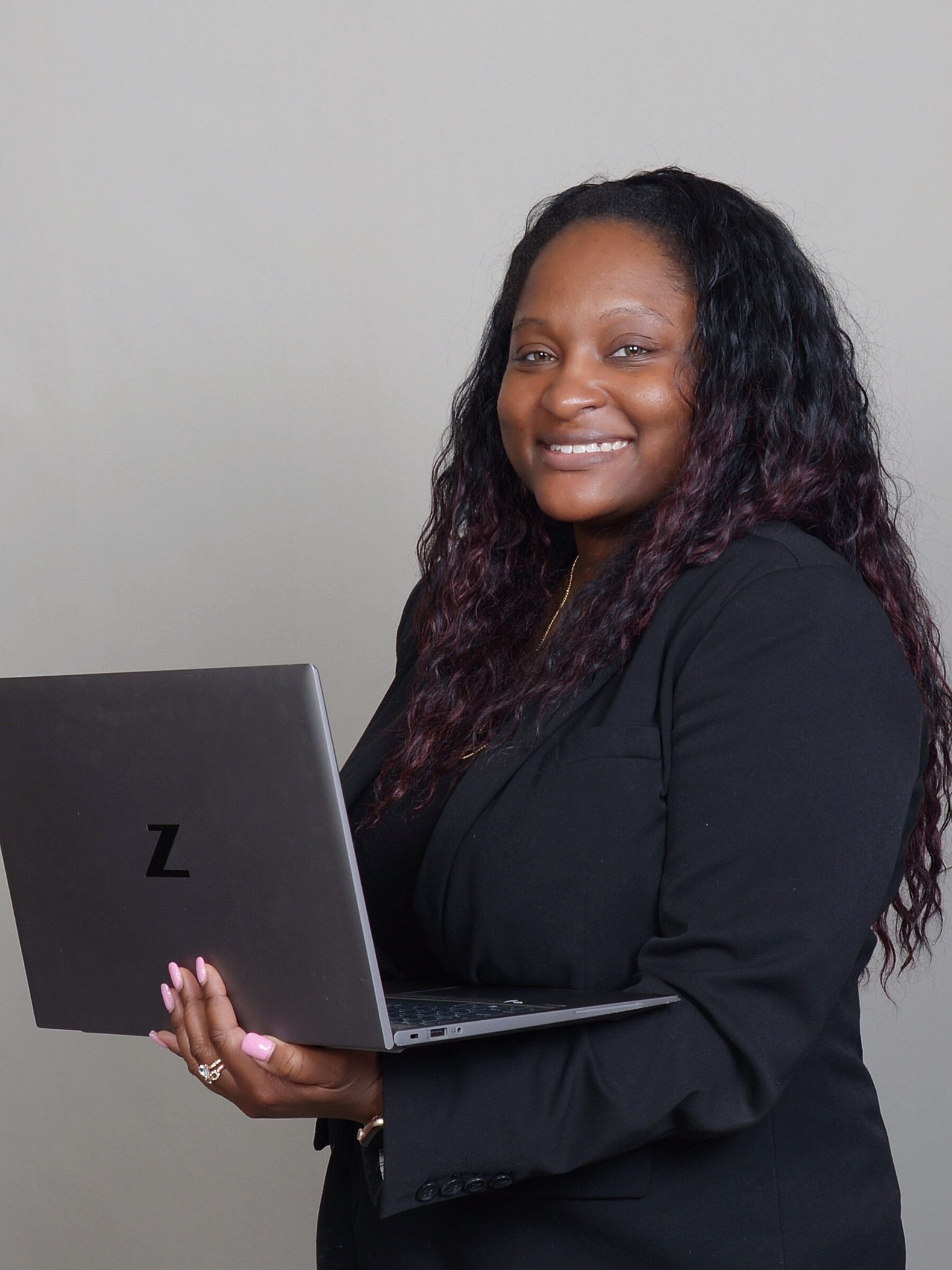 Shakara Lawrence holding a laptop