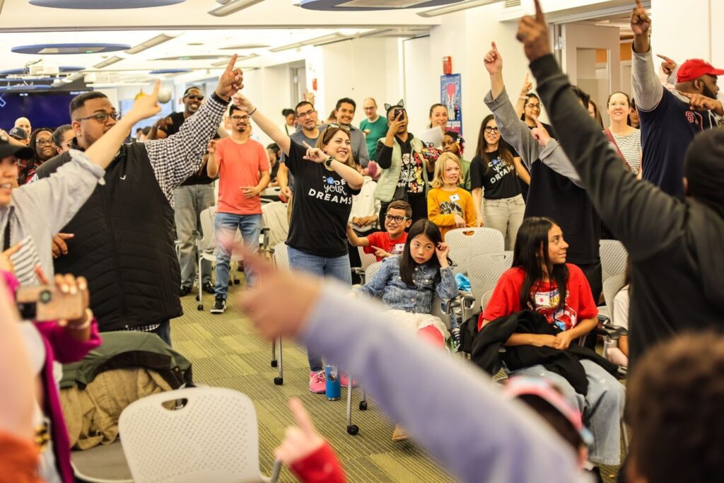 Adults and children participating in a Code Your Dreams event