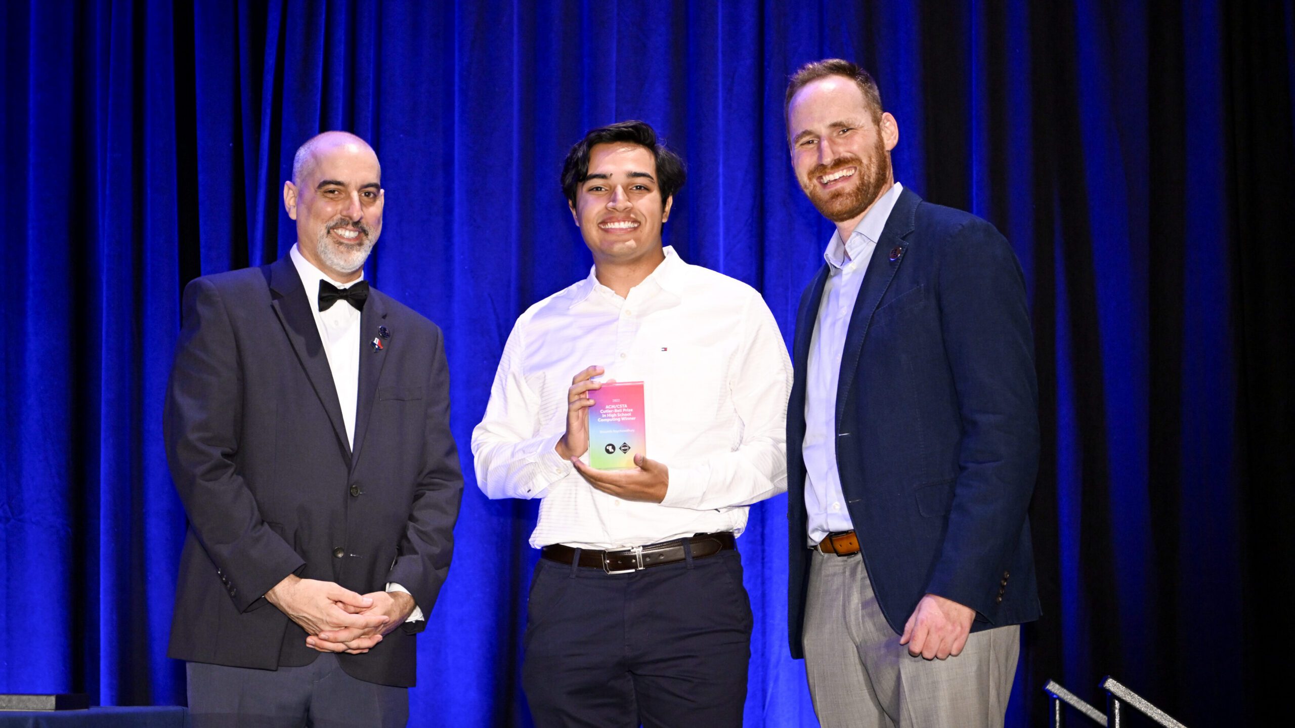 A Cutler-Bell winner from 2022 poses with CSTA's executive director and board chair.