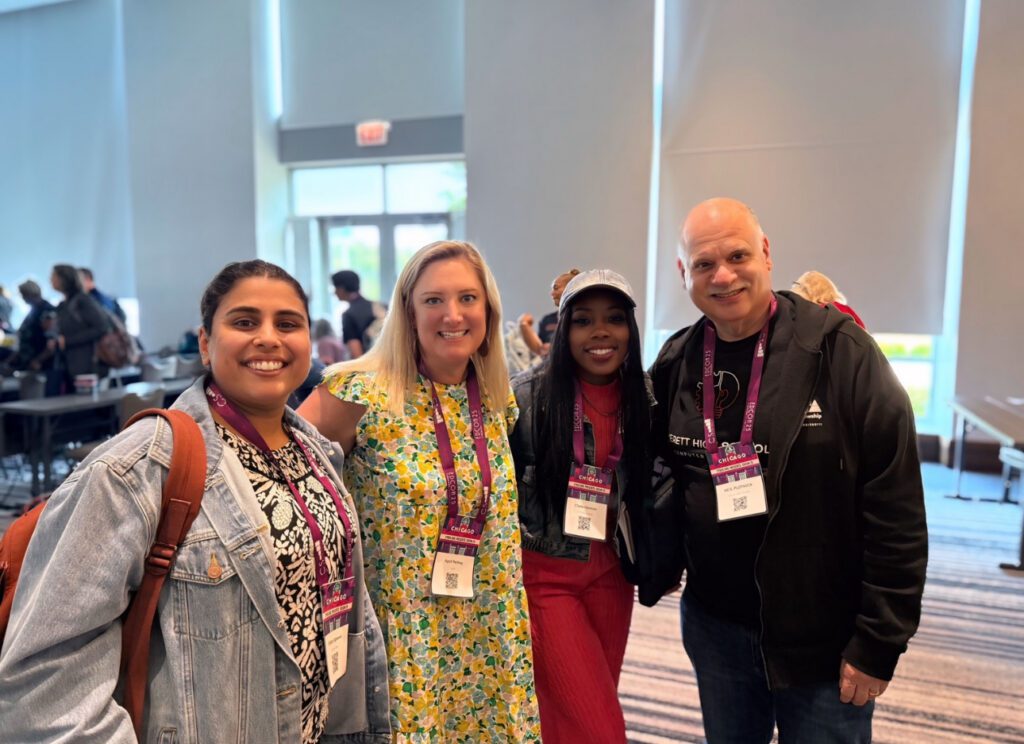 Chala attends a conference with three other impact fellows from her cohort. 